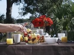 CU  Woman serving fruit salad to boyfriend at breakfast / Charleston, South Carolina, USA Stock Footage