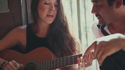She plays guitar and sing for him Stock Footage