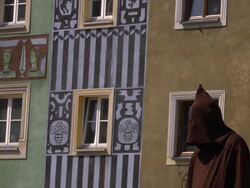 MS of a hangman in front of Old Town Houses Stock Footage