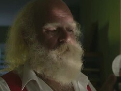 C/U man similar to Santa looking to a crystal ball with snow in his hand and then the strong sun through a window Stock Footage