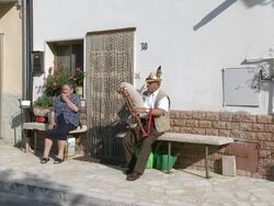 MS Shot of man playing bagpipe seating in front of house / San Polo Matese,Molise, Italy  Stock Footage