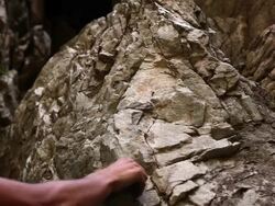 Static shot of a rock-climber's hand grasping craggy rocks. Stock Footage