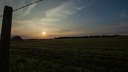 Timelapse of sun setting over rural field. Stock Footage