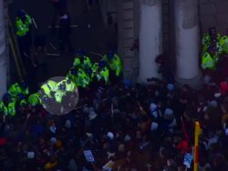 Aerials of police officer trampled at Protests News Clip