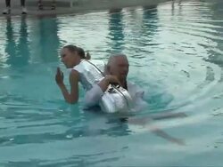 Sir Richard Branson swims in hotel pool with model Karolina Kurkova Stock Footage