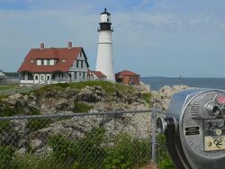 MS Shot of Portland Maine famous Head Light Lighthouse in USA on water with telescope with rocks and ocean on cliff / Portland, Maine, United States Stock Footage