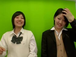 MS Shot of photo cabin with Japanese teenagers posing between friends / Tokyo, Japan Stock Footage