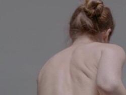 Back view of young, naked woman moving Stock Footage
