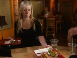 Guys talking at coffee house and girl waits on them Stock Footage