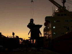 MS Unloading bags in building sit at sunset / Djibouti Stock Footage