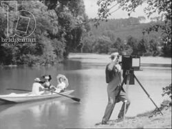 Re-enacted scenes of a photographer with boaters, 1880s, made in France, 1956 Stock Footage