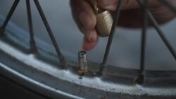 inflating motorcycle tire Stock Footage