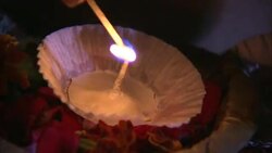 A match lights a diya for Diwali. Stock Footage