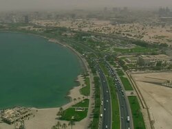 MS AERIAL Shot of traffic moving on highway in city near ocean / Qatar Stock Footage