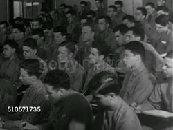 1943: US NAVY PRE-FLIGHT SCHOOL: VS Naval cadets seated in classroom, Lieutenant teaching, Battle of Midway chart on blackboard, teacher holding model of aircraft carrier, MS Cadet listening.   Military training, WWII, World War II. Instructional Video