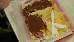 Anonymous diner eating chilli dog News Clip