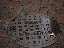 Out of focus to in focus shot of Chicago Sewer manhole cover Stock Footage