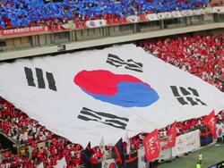 WS SLO MO View of Red Devil (Korean cheering squad) hand raised huge South Korean Flag to fold at the Seoul World Cup Stadium in Sangam / Seoul, South Korea  Stock Footage