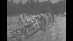 USAAF crews prepare bombs for loading onto WWII bomber planes News Clip