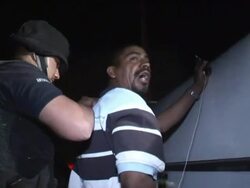 April 3 2009 MS Mexican police officers frisking suspect on street, Juarez, Chihuahua, Mexico, AUDIO Stock Footage