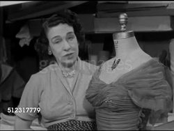 1952: DESIGNER CEIL CHAPMAN:  MS Fashion designer Ceil Chapman standing next to headless mannequin w/ ruffle off shoulder line dress talking about fashion, what American women like to wear. Instructional Video