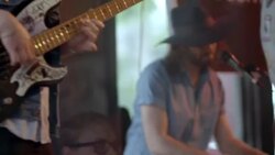 Bassist plays as keyboardist sings into microphone with rock band in Austin bar Stock Footage