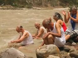 Five senior people playing at riverbank, Ganges River, Rishikesh, Uttarakhand, India Stock Footage