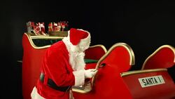 Father Christmas, Santa painting his sleigh ready for use Stock Footage