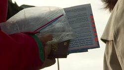 Anon Voter Holding Passport by DutcPolling Station News Clip