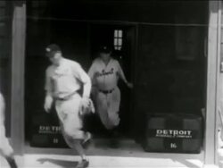 B/W 1938 line of baseball players in uniforms (Detroit Tigers) running out of building Stock Footage