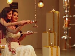 Young woman celebrating diwali festival with her daughter Stock Footage