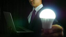 Businessman with labtop and light blub Stock Footage