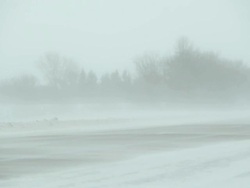 Winter Blizzard with Blowing Snow Across Highway and Vehicles Stock Footage