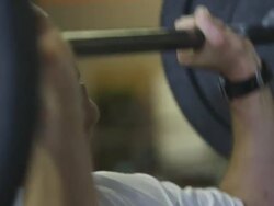 Close-up handheld shot of a man weightlifting at a gym Stock Footage