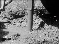 1947: USA OIL INDUSTRY: SEARCHING FOR GAS & OIL: WS Exploratory mobile drill truck w/ derrick, men setting equipment, CU Drilling down hole into mud & water, male in hard hat operating drill.   Fossil fuel, non-renewable resource, energy. Instructional Video