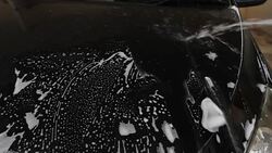 hand of Man washing the car using the yellow sponge with foam Stock Footage