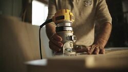 White Male Carpenter in his Forties Routers a Piece of Wood Stock Footage