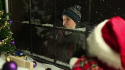 Child looking through shop window at Christmas Stock Footage
