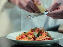 Chef grating cheese on spaghetti Stock Footage