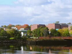 WS View of river panoramic with church and skyline in Northern New England in fall colors foliage in October / Bangor, Maine, United States Stock Footage