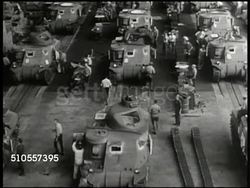 1941: AMERICA UNITED: WAR FACTORIES: INT WS Men & women working in factory. HA WS Workers constructing tanks on assembly line. MS Middle-aged man turning crank. Industry, World War II, WWII, war effort, home front Instructional Video