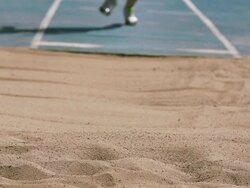 Track and field athlete in slow motion doing long jump Stock Footage