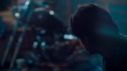 Man sitting in motorcycle workshop drinking coffe Stock Footage