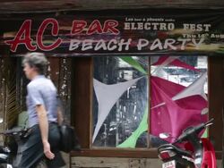 AC bar on Koh Tao beach and tourists walking News Clip
