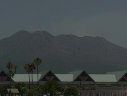 Sakurajima volcano overshadows the city of Kagoshima in Japan Stock Footage