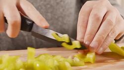 Woman slicing organic bell pepper Stock Footage