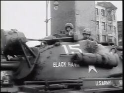 B/W 1961 two US soldiers riding tank on Berlin street / Cold War / Germany / newsreel Stock Footage