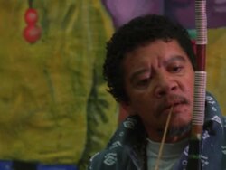 Tilt down of a man playing a Uhadi bow Stock Footage