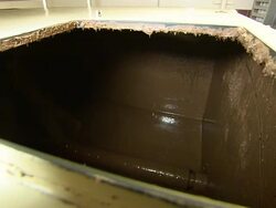 Medium Close Up static - A paddle mixes liquid chocolate in a tank /  Ohio, United States Stock Footage