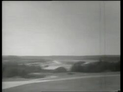 B/W de Havilland night fighter jet flying low over ground / Air show / England / SOUND Stock Footage